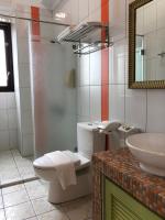 a bathroom with a toilet and a sink and a mirror at Remember Sea View B&amp;B in Huxi