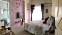 a bedroom with a bed and a tv and a window at Remember Sea View B&amp;B in Huxi