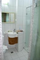 a white bathroom with a sink and a shower at Remember Sea View B&amp;B in Huxi