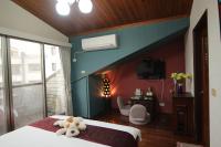 a bedroom with a bed with a teddy bear on it at Yilan Pine Villa Homestay in Luodong