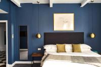 a bedroom with blue walls and a large bed at ABode Manchester in Manchester