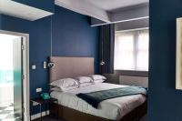 a bedroom with a bed with blue walls and a window at ABode Manchester in Manchester