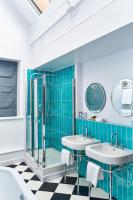 a bathroom with two sinks and a shower at ABode Manchester in Manchester
