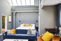 a bedroom with a bed and a blue couch at ABode Manchester in Manchester
