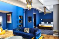 a blue living room with a couch and a bed at ABode Manchester in Manchester