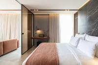 A bed or beds in a room at Perianth Hotel