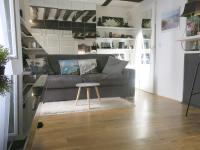 a living room with a couch and a table at Studio Marais Charlot CityCosy in Paris