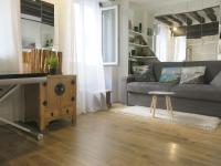 a living room with a couch and a table at Studio Marais Charlot CityCosy in Paris