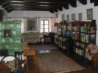 a living room with book shelves filled with books at Ferienhaus Himmelreichmühle in Rettenberg
