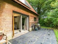 a patio with a sliding glass door next to a house at This accommodation is full of atmosphere and on a beautiful estate in Zedelgem