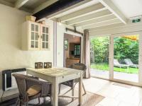 a dining room with a table and chairs and a patio at This accommodation is full of atmosphere and on a beautiful estate in Zedelgem