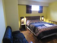 a bedroom with a bed and a couch in it at Hotel Sueños Dorados in Juliaca