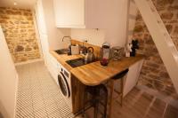 a small kitchen with a counter and a sink at Hamac Suites - Studio Ainay 4 - Hyper centre Lyon in Lyon