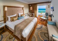 a bedroom with a large bed with a view of the ocean at Sousse Palace Hotel &amp; Spa in Sousse