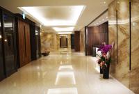 a hallway in a hotel with a vase of flowers at Beitou Hot Spring Resort in Taipei