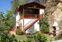 a small house with a balcony and a staircase at Casa Rural Priena in Covadonga