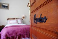 a bedroom with a bed and a wooden door at Casa Rural Priena in Covadonga