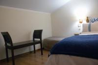 a bedroom with a bed and a desk with a chair at Casa Rural Priena in Covadonga