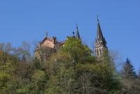 an old castle on top of a hill with trees at Casa Rural Priena in Covadonga