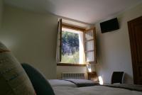 a bedroom with two beds and a window at Casa Rural Priena in Covadonga