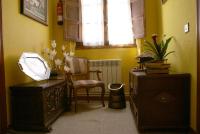 a room with a chair and a table and a window at Casa Rural Priena in Covadonga