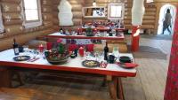 a table with plates of food and wine on it at Noclegi Styrnol & SPA in Zawoja