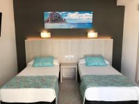 A bed or beds in a room at Hostal Cervantes