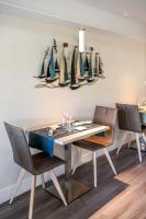 a dining room with a table and chairs at Les Vagues Hôtel Restaurant in Biscarrosse-Plage