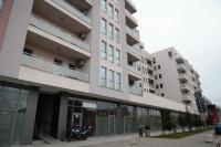 a building with a motorcycle parked in front of it at Apartman SUN in Inđija