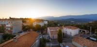 an aerial view of a town with buildings and the sunset at Citta di Lume Suites &amp; Lofts in Porto-Vecchio