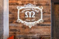 a sign for a house hotel on a wooden wall at Moore Hotel in Seattle