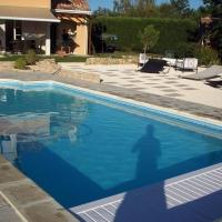 a shadow of a person standing next to a swimming pool at Villa du Courboulay in Sargé Les Le Mans 