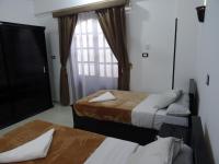 A bed or beds in a room at Nile Sunrise Flats