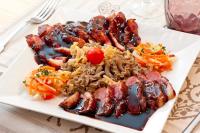 um prato de comida com carne e massas numa mesa em Chalet Hotel La Tarine em Peisey-Nancroix