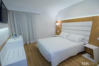 A bed or beds in a room at Hotel Spa Nanin Playa