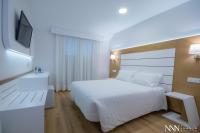 A bed or beds in a room at Hotel Spa Nanin Playa