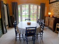 a dining room with a white table and chairs at Holiday Home Le chant des milans by Interhome in Ondres