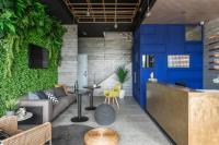 a lobby with a blue door and plants at Hido Hostel in Kenting