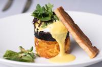 un trozo de comida con salsa en un plato blanco en Astley Bank Hotel, en Darwen