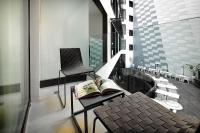 a balcony with a chair and a book on a table at Olivia Balmes Hotel in Barcelona