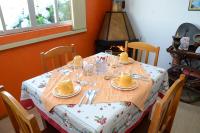 a dining room table with plates and glasses on it at Pousada Colina Da Neve in São Joaquim