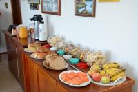 a table with plates of bread and fruit on it at Pousada Colina Da Neve in São Joaquim
