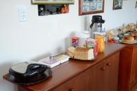 a wooden counter with food and a telephone on it at Pousada Colina Da Neve in São Joaquim