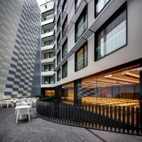 a building with tables and chairs in front of it at Olivia Balmes Hotel in Barcelona