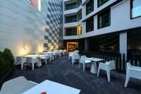 a row of tables and chairs outside of a building at Olivia Balmes Hotel in Barcelona