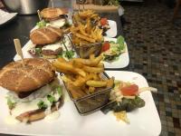 three plates of food with sandwiches and french fries at Hotel du Rempart in Sancerre