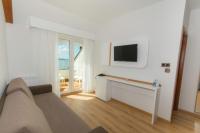 A television and/or entertainment centre at Hotel Spa Nanin Playa