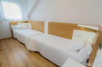 A bed or beds in a room at Hotel Spa Nanin Playa