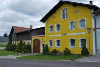 a yellow house with arrows painted on the side of it at Bauernhof Familie Tauber-Scheidl in Grossmeinharts