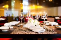 a table with wine glasses and napkins on it at Hotel de l'Opera Hanoi - MGallery in Hanoi